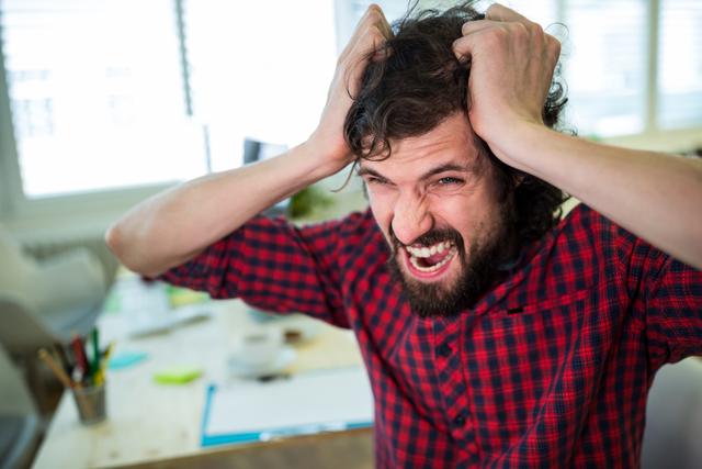 Frustrated Male Graphic Designer Pulling Hair in Office - Download Free Stock Images Pikwizard.com