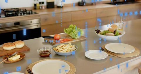 Modern kitchen island presenting casual dinner spread featuring fries, burger buns and fresh salad