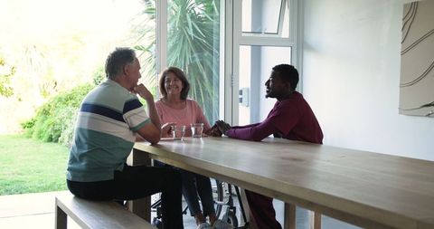 Intergenerational bonding at home with senior couple and young man
