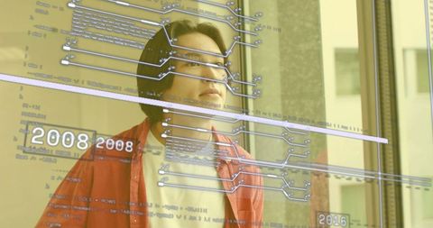 Businessman Analyzing Digital Data Visualizations in Modern Office