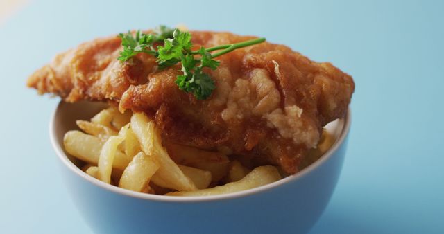 Crispy Fish with Golden Fries in Blue Bowl Sitting on Light Blue Surface - Download Free Stock Images Pikwizard.com