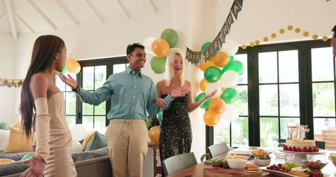 Smiling Friends Celebrating a Birthday in Sunny Living Room
