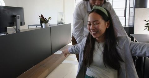 Colleagues having fun in modern office environment