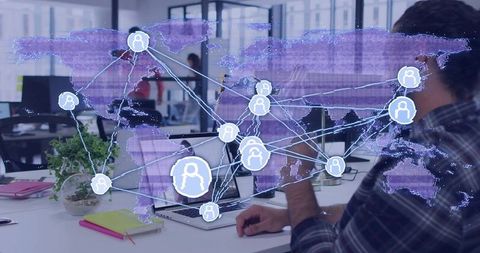 Remote team connecting global network over laptop in modern open office with data overlay