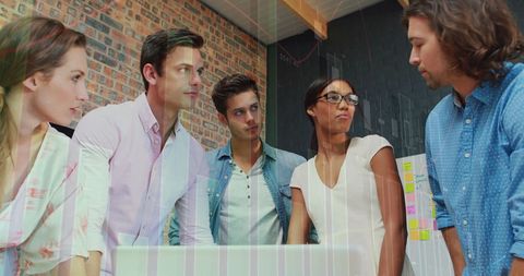 Diverse Team Analyzing Digital Financial Data in Workspace