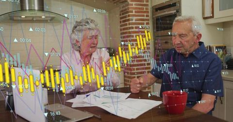 Senior couple reviewing retirement budget with digital financial charts and home planning