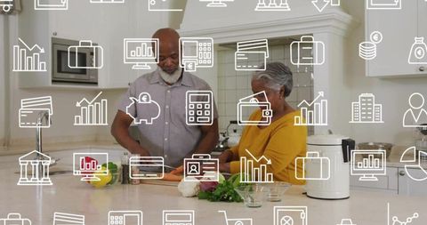Senior black couple cooking together on modern kitchen island preparing healthy meal