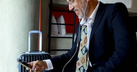 Businessman Enjoying Conversation in Hotel Room with Luggage