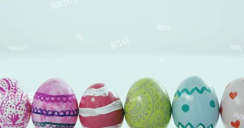 Glossy handpainted easter eggs row with paisley and chevron patterns on pale blue gradient