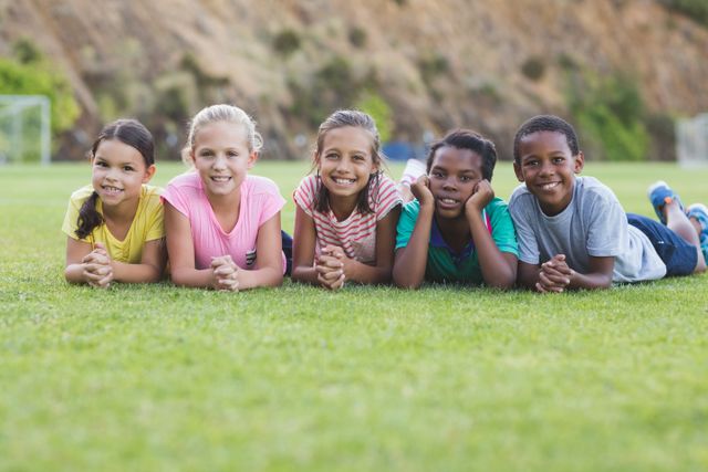 Diverse Group of Children Lying on Grass Smiling - Download Free Stock Photos Pikwizard.com