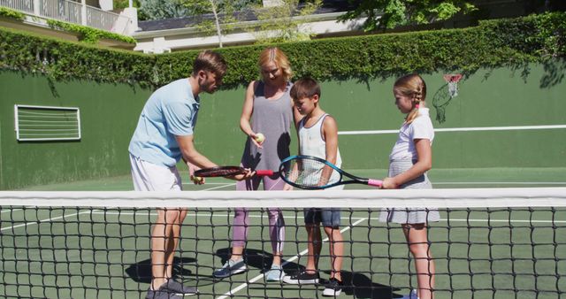 Family Learning to Play Tennis Together on Outdoor Court - Download Free Stock Images Pikwizard.com