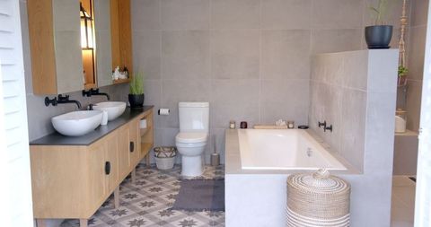 Luxury modern bathroom with built-in tub and vessel sinks