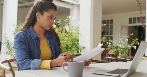 Woman Working Remotely in Garden with Laptop