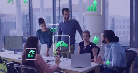 Diverse team collaborating on sustainable business strategy with eco icons in modern office