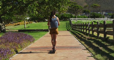 Playful Journey African Woman on Scenic Park Scooter Ride