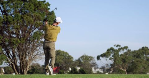 Male Golfer Taking a Shot on Lush Green Golf Course - Download Free Stock Images Pikwizard.com