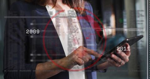 Businesswoman analyzing digital data with futuristic hud overlay