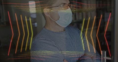 Man wearing mask in neon-lit modern office environment