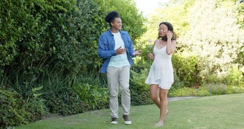 Couple Enjoying Picnic and Bonding Outdoors with Laughter and Flowers