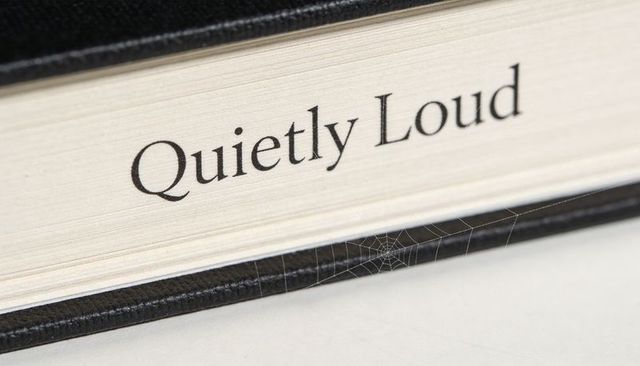 Quietly loud book fore-edge with cobweb macro closeup conveying neglect and contrast