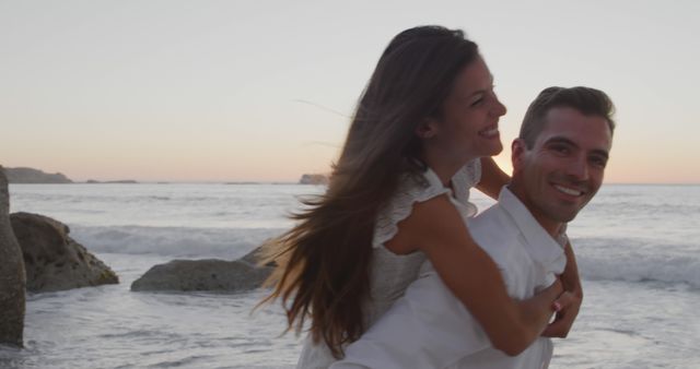 Happy Couple Piggyback Ride on Beach at Sunset - Download Free Stock Images Pikwizard.com