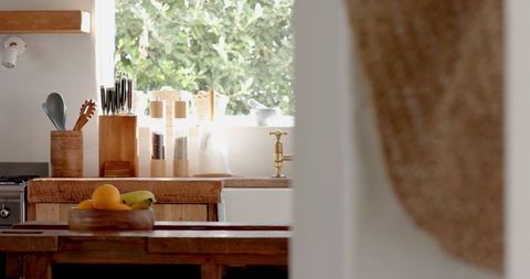 Rustic kitchen with fruit bowl and natural greenery
