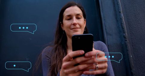 Woman engaging with digital chat interfaces on smartphone