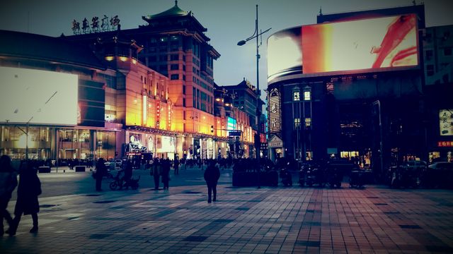 Bustling City Square Adorned with Neon Lights in Evening - Download Free Stock Photos Pikwizard.com
