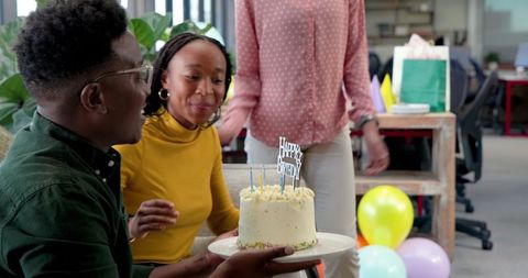 Coworkers Celebrating Birthday with Cake in Office