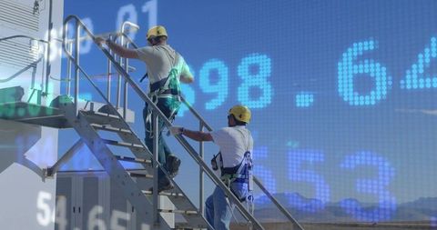 Technicians Climbing Metal Staircase Wearing Harnesses, Hard Hats with Digital Overlay
