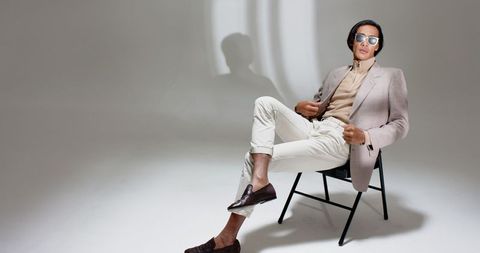 Stylish Asian Man in Minimalist Studio Setting with Beige Outfit