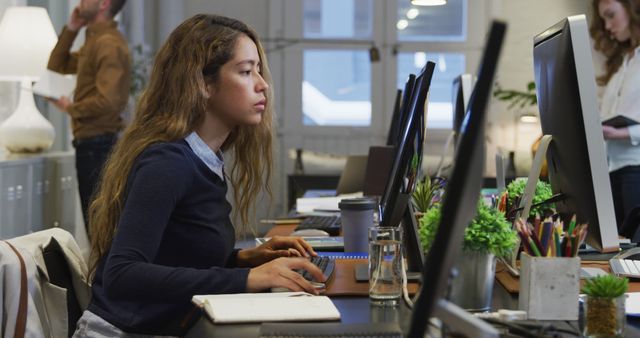 Focused Young Woman Working at Office Desk on Computer - Download Free Stock Images Pikwizard.com