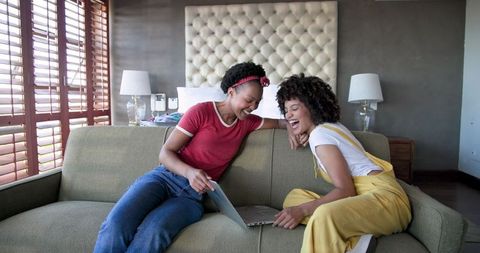 Casual friends enjoying digital content together at home