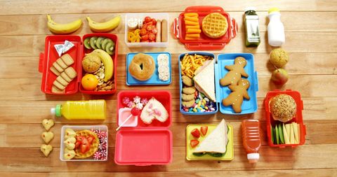 Assortment of kids lunches displayed on wooden table