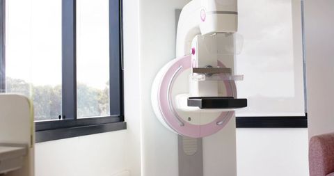 Modern mammography unit in bright clinic room with large window and minimalist medical interior