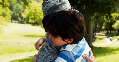 Soldier in Uniform Hugging Son in Sunny Park - Download Free Stock Images Pikwizard.com