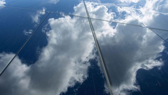 Cumulus Clouds Reflecting on Glass Facade with Rain Streaks, Mullions and Urban Grid