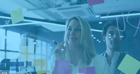 Business Team Engaged in Creative Planning on Glass Board