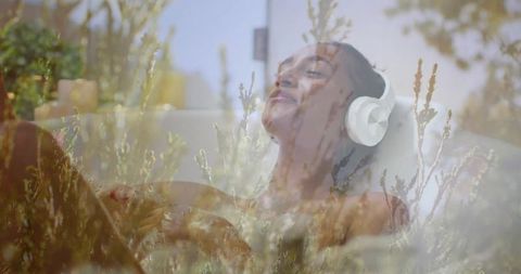 Relaxing Woman Enjoying Music with Headphones While Bathing