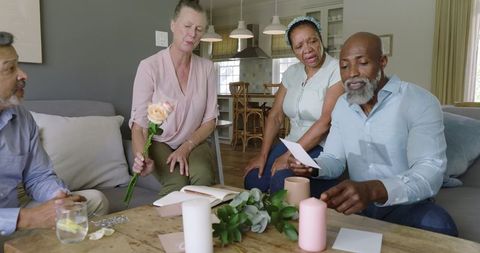 Senior Friends Celebrating with Cards and Flowers