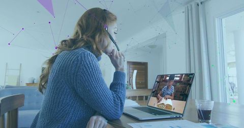 Businesswoman Using Headset for Virtual Meeting with Data Overlay