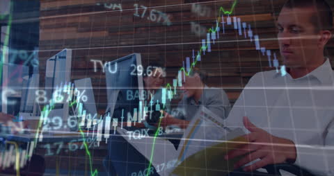 Business Professionals Analyzing Financial Data with Graphs