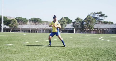 Soccer player training on field under clear sky