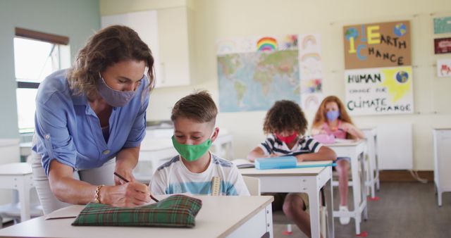 Teacher Helping Students While Wearing Masks in Classroom - Download Free Stock Images Pikwizard.com