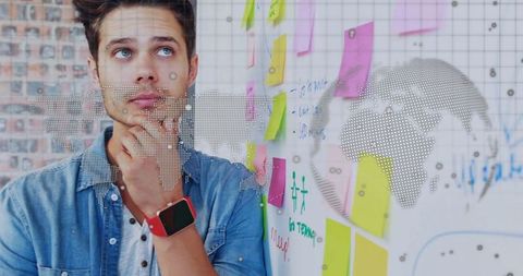 Thoughtful Analyst Brainstorming With Sticky Notes and World Map Overlay