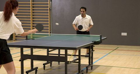 Intense Table Tennis Match in Gymnasium Adventure