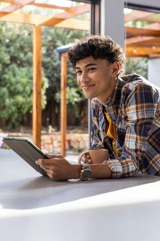 Young hispanic male enjoying modern lifestyle at home