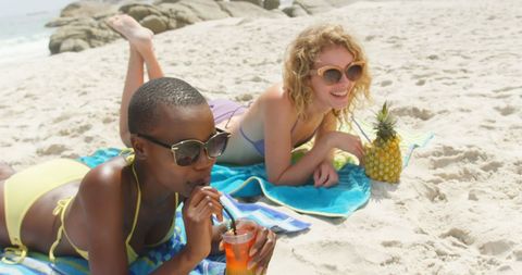 Diverse Friends Relaxing on Sandy Beach in Sunlit Scene