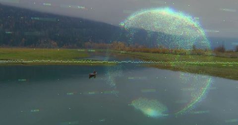 Solitary man sitting in rowboat on misty lake viewing holographic data globe and overlays