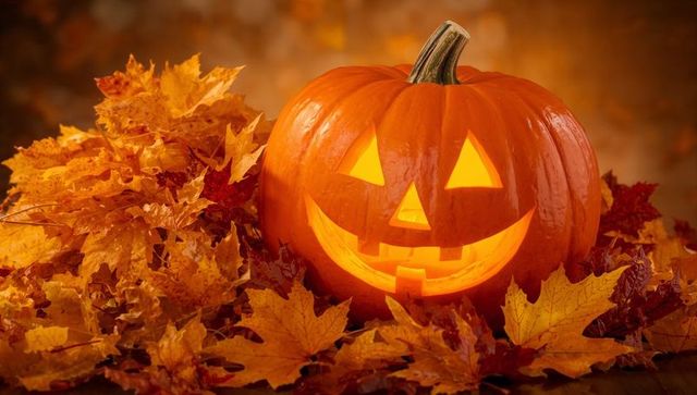 Glowing Jack-o'-Lantern with Autumn Maple Leaves in Rustic Setting